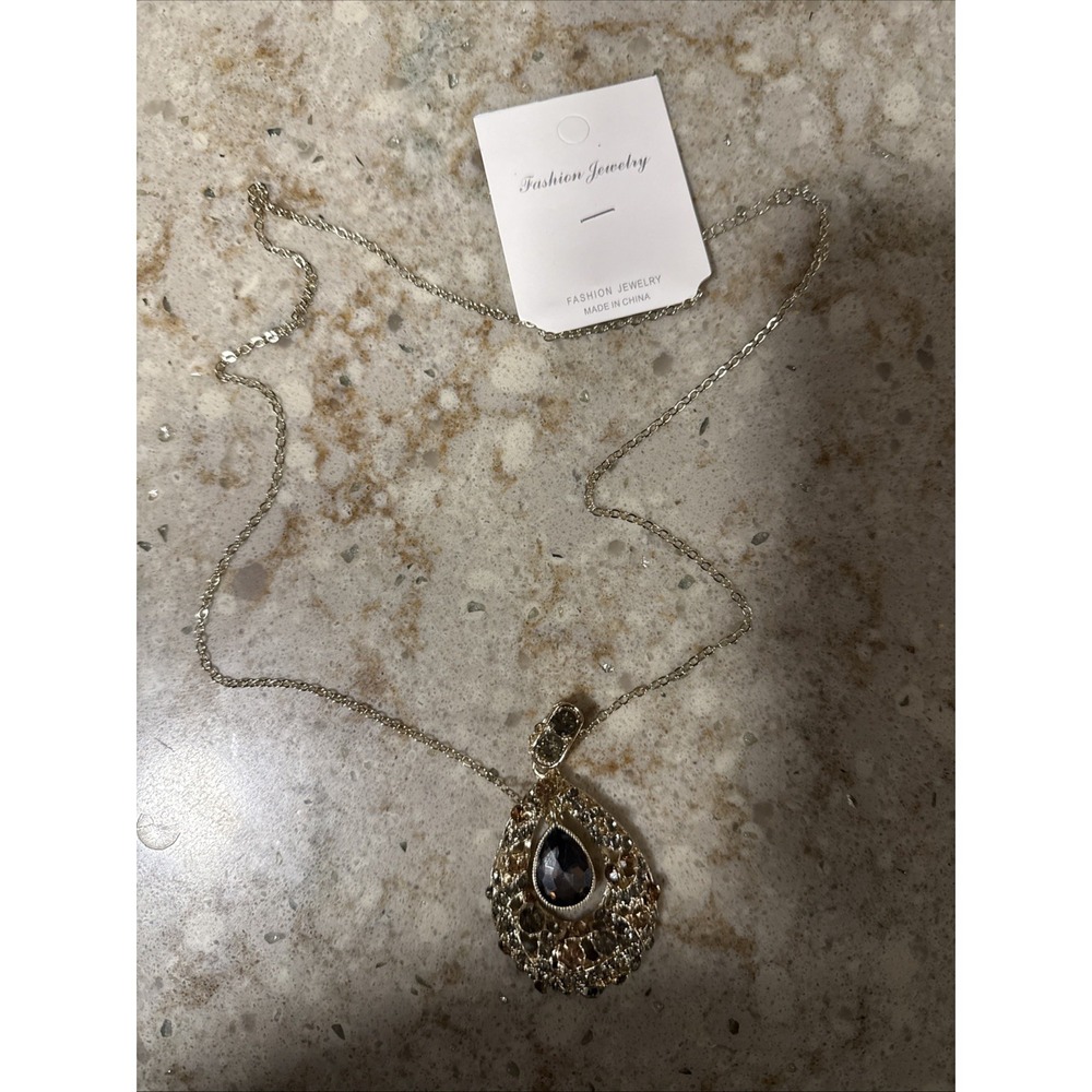 Long necklace with large gold-plated steel pendant and champagne zircons